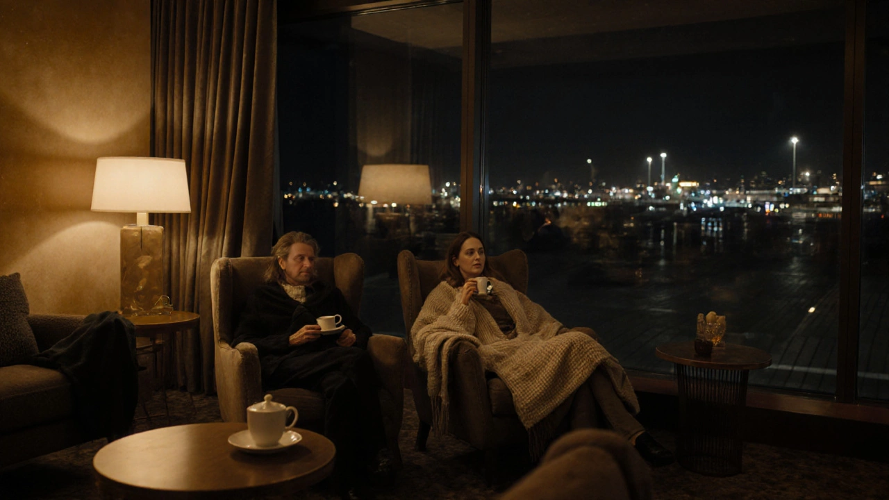 Person sleeping comfortably in a quiet airport lounge with recliners and warm ambient light.